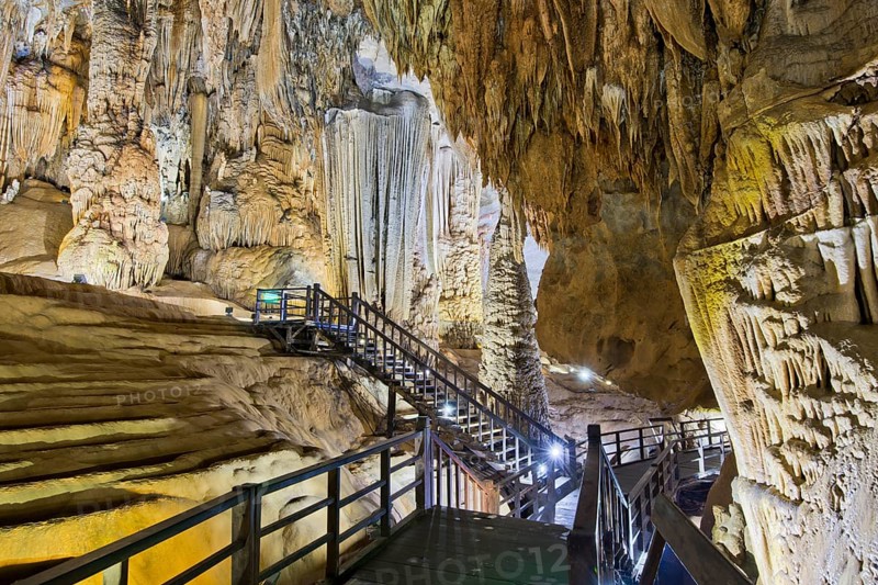 Boardwalk through illuminated dripstone cave