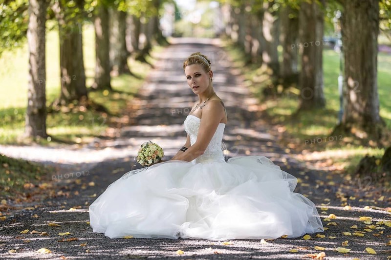Young blonde woman rushing in a white wedding dress
