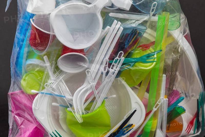 Garbage bag filled with disposable crockery