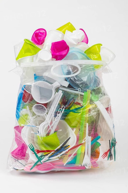 Garbage bag filled with disposable crockery