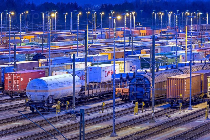 Parked freight cars on tracks at night