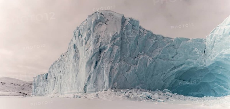 Iceberg in a frozen fjord