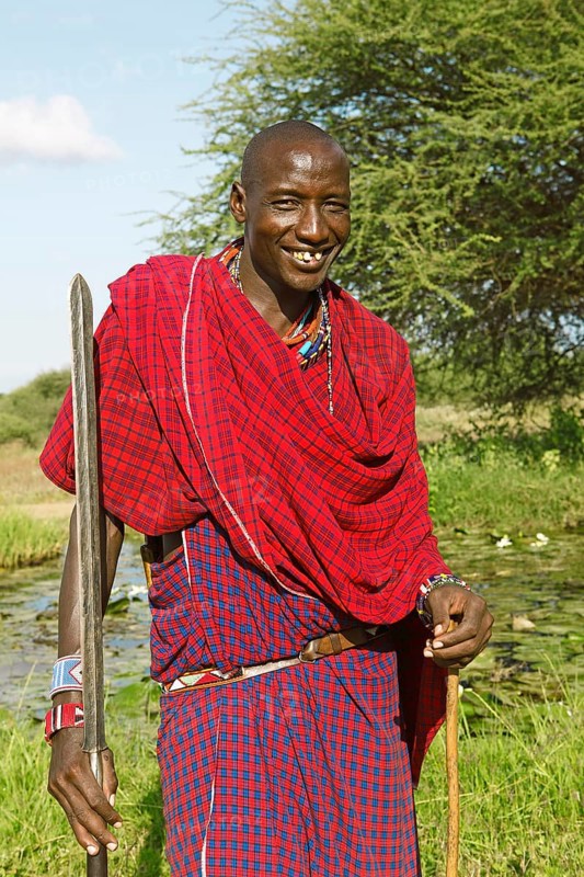 Male Maasai in traditional Shuka clothing with spear