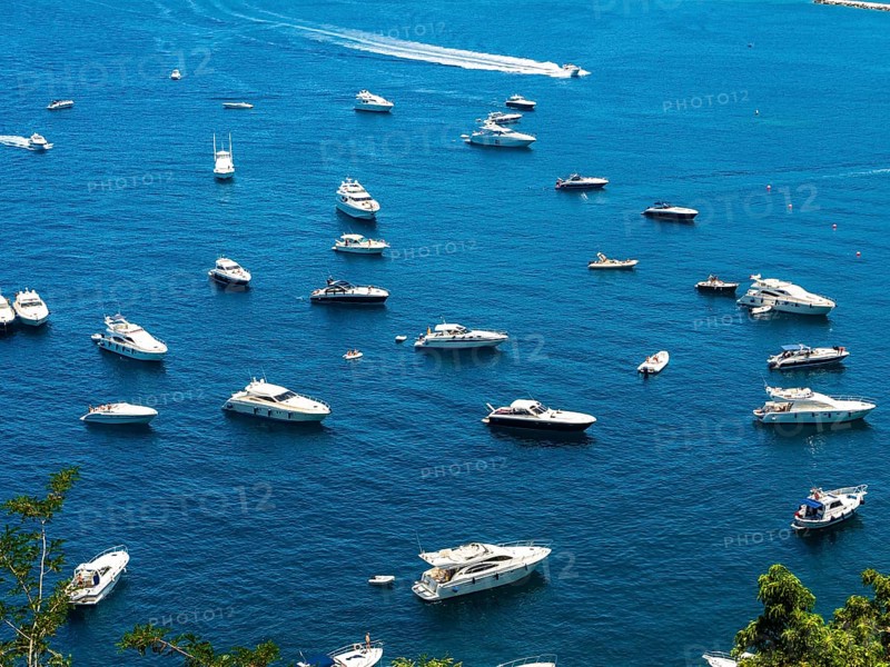 Motorboats anchor in the bay of Lacco Ameno
