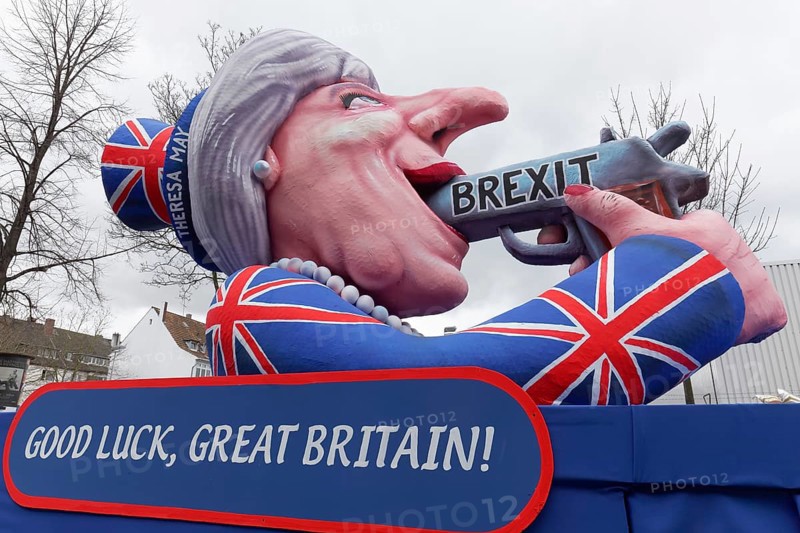 British Prime Minister Theresa May holds gun in her mouth