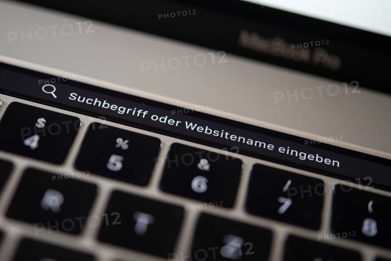 Backlit keyboard and Touch Bar showing search bar