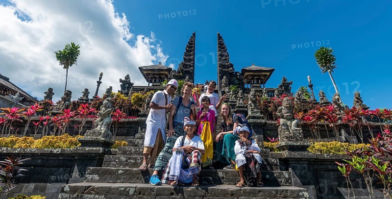 Devout Balinese posing with European tourists