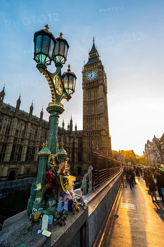 Big Ben and flowers commemorating terrorist attack on Westminster Bridge