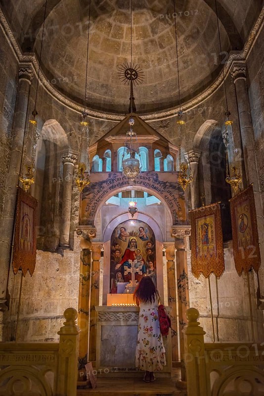 Woman praying in a side chapel of the Tomb Chapel