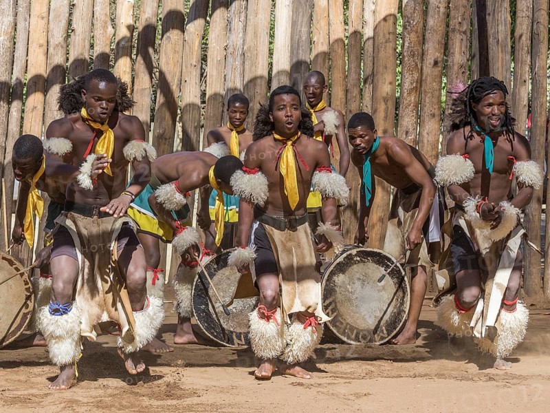 Men in traditional clothing during dance performance