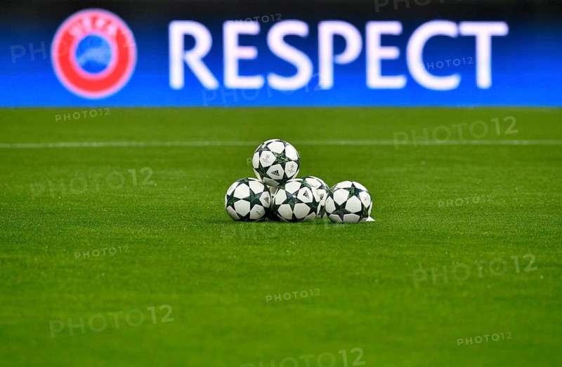 Match balls with Champions League Logo in front of UEFA perimeter advertisement