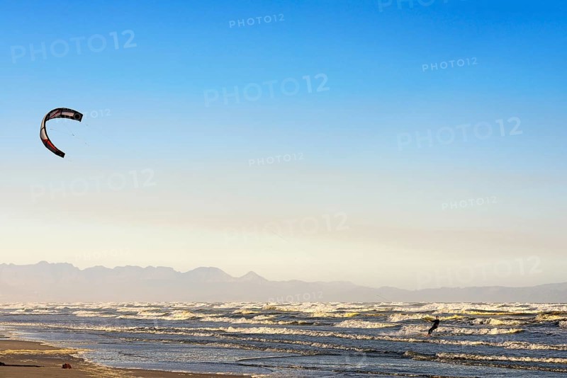 Kitesurfers at high waves