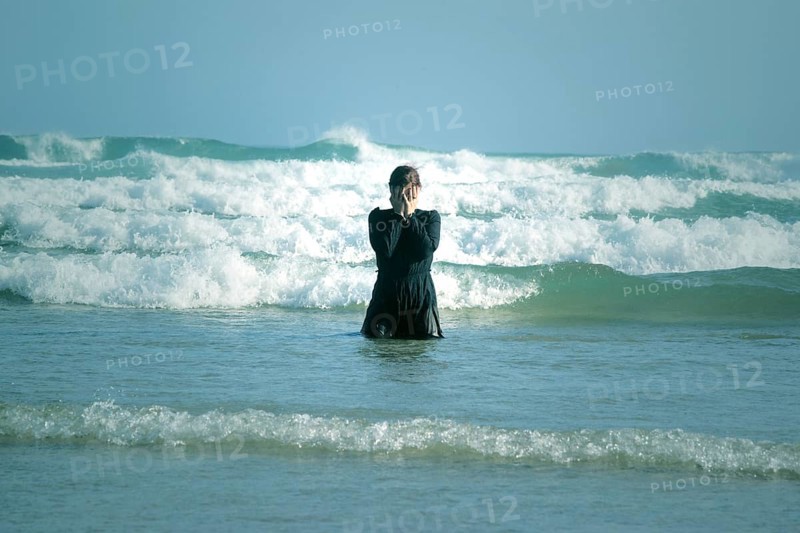 Woman in black dress with mask