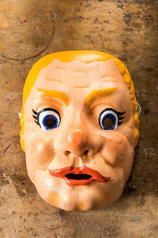 Painted wooden mask on a workbench