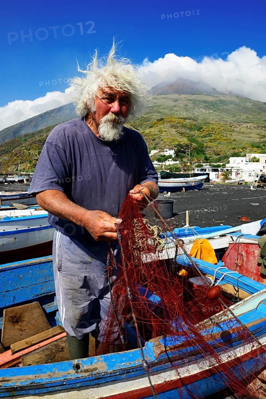 Fishermen repair nets at Scari Beach