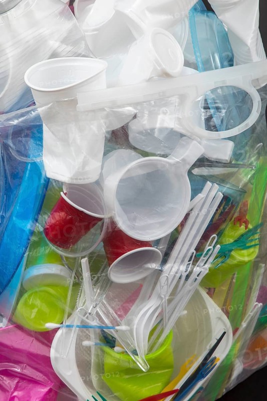 Garbage bag filled with disposable crockery