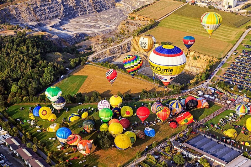 Different colored hot air balloons rising into the air