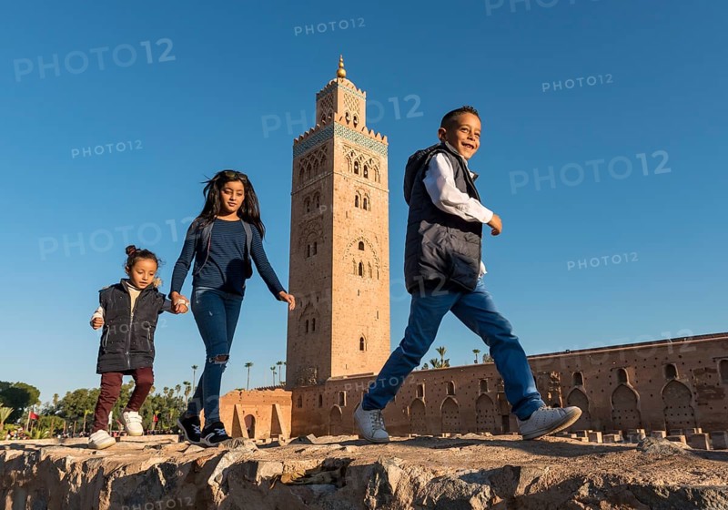 Marrocan children play outside Koutoubia Mosque