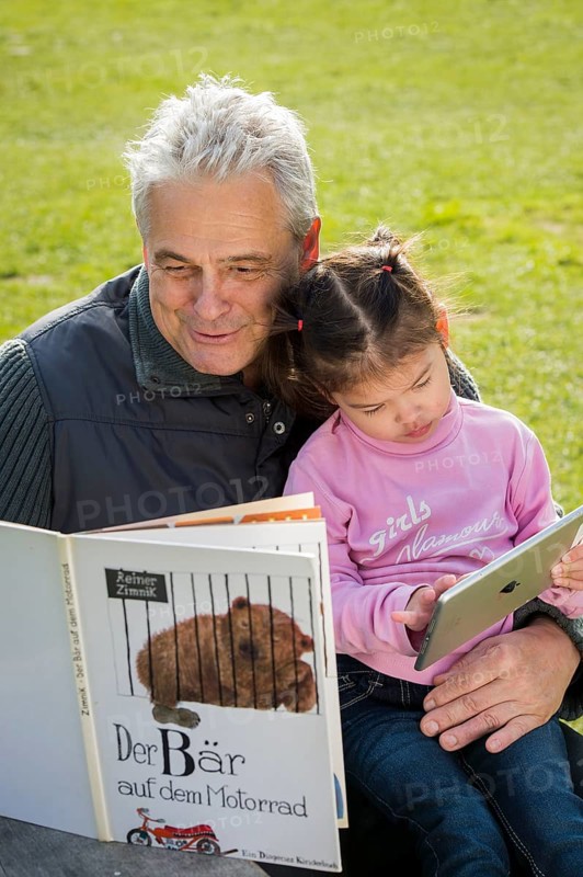 Father reading book to daughter