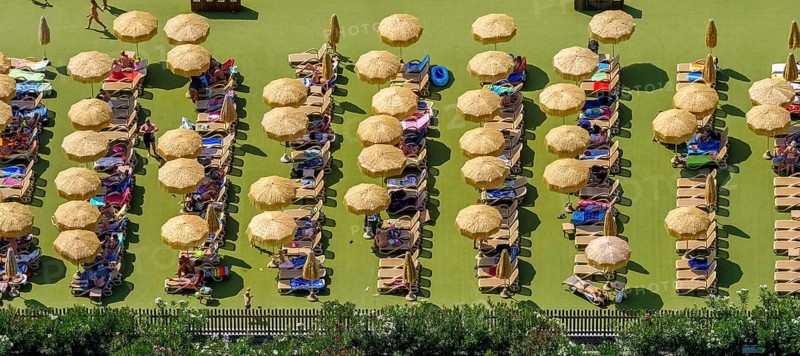Camping guests on sun terrace with parasols