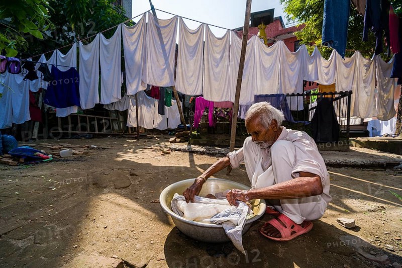Man doing laundry by hand in courtyard
