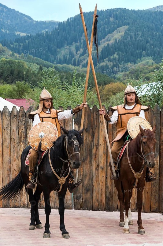 Two men on horseback in front of the entrance to the Kazakh ethnographic village aul Gunny