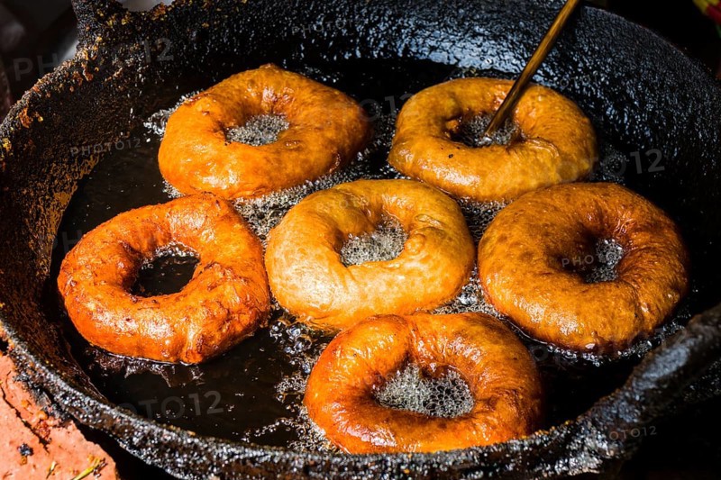 Doughnuts are fried in a pan with hot oil