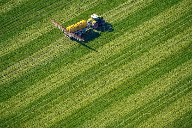 Tractor with pesticide sprayer