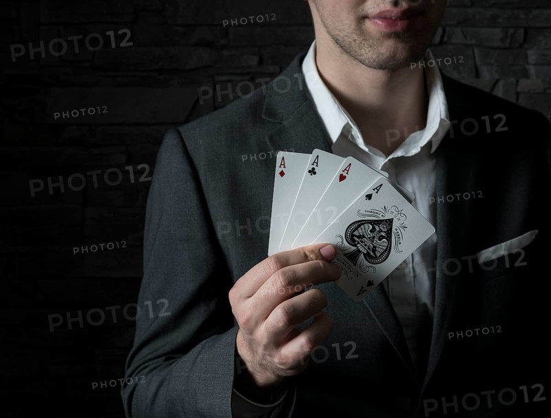 Card artist Jeremy Rowe holds playing cards in his hand