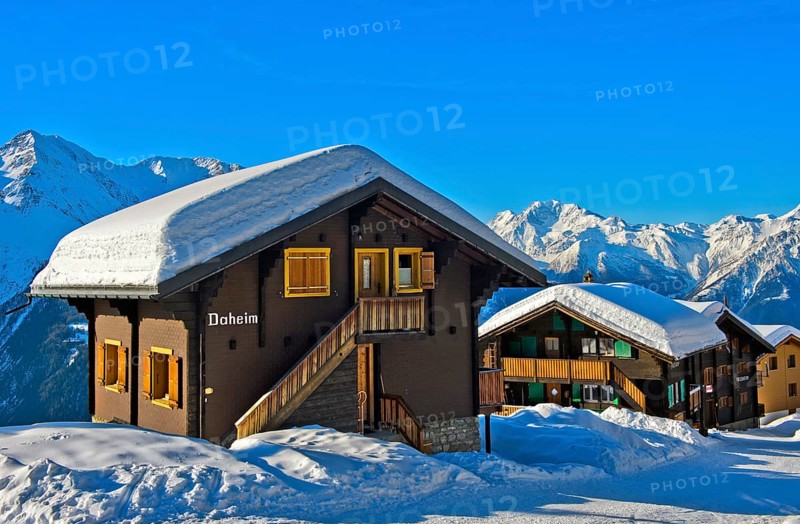 Swiss chalet with a thick layer of snow on the roof with Fletschhorn