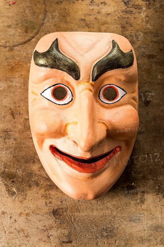 Painted wooden mask on a workbench