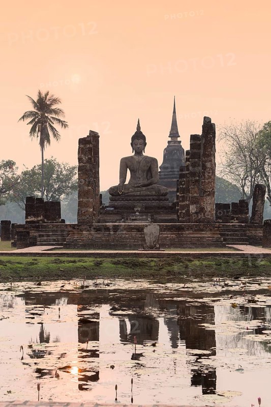 Temple hall Wat Mahathat Sukhothai with witting Buddha