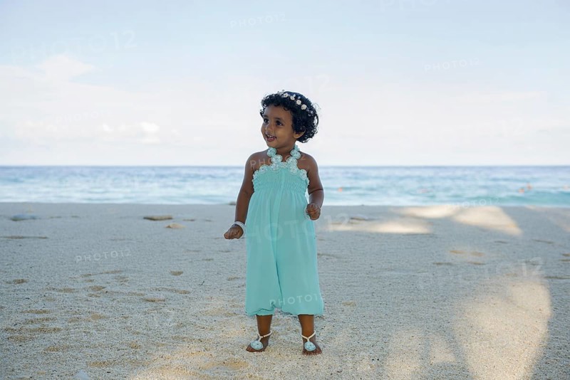 Little Maldivian girl on the sandy beach