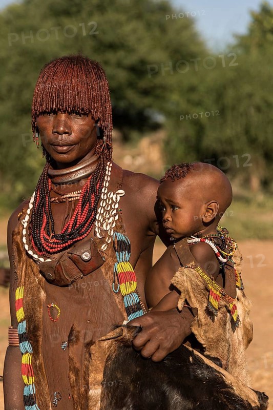 Woman with baby from the Hamer tribe in traditional dress
