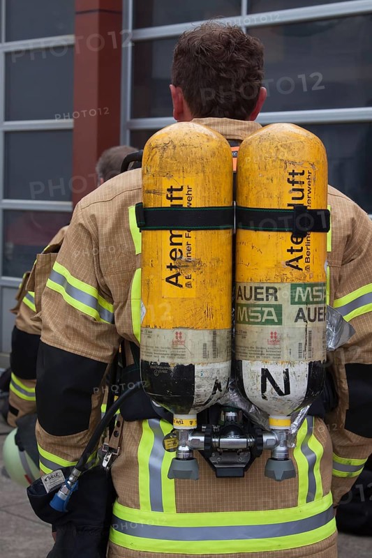 Firefighter with breathing air bottles on his back
