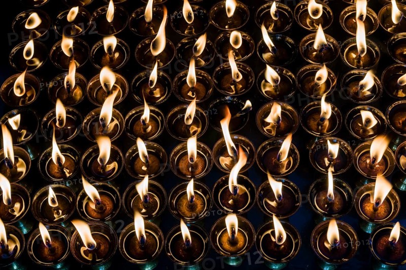 Tibetan butter lamps with burning flames