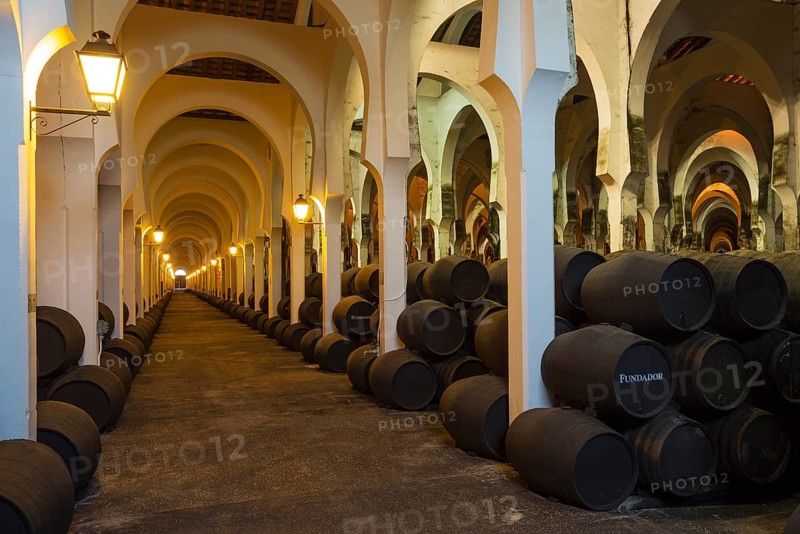 Stacked oak barrels in the wine cellar La Mezquita