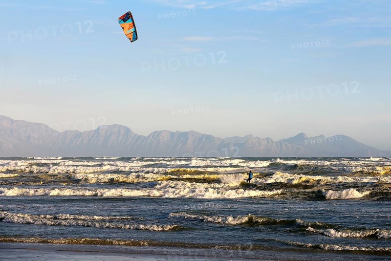 Kitesurfers at high waves