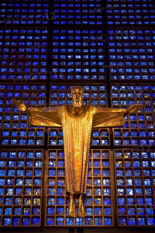 Crucifix in front of a glass facade