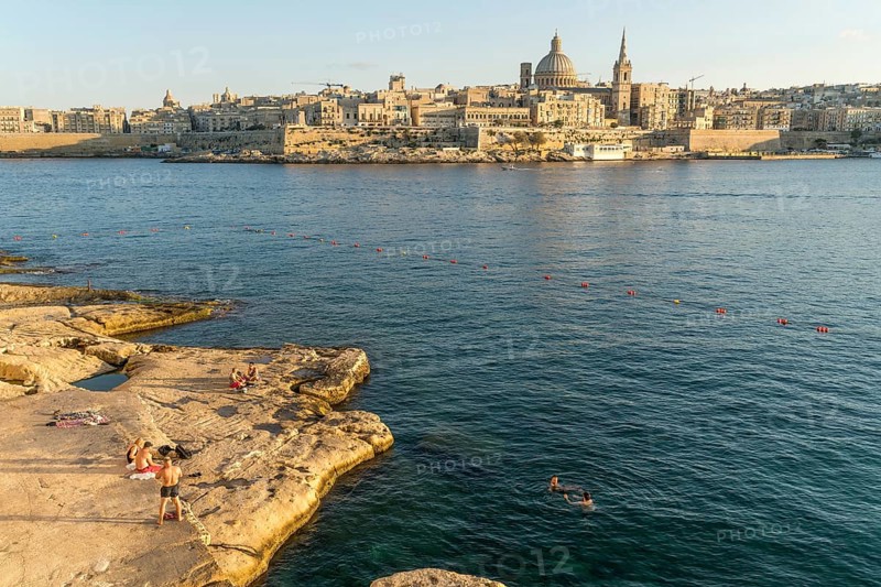 Bathing place on the rocks of Tigne Seafront with city view