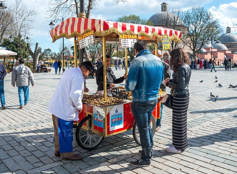Salesman at his Sweet chestnut stall in Sultan Ahmed Park