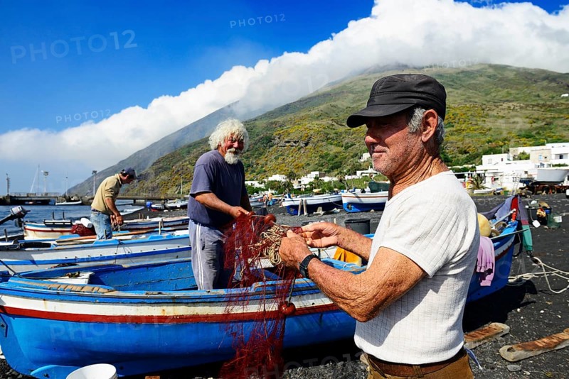 Fishermen repair nets at Scari Beach