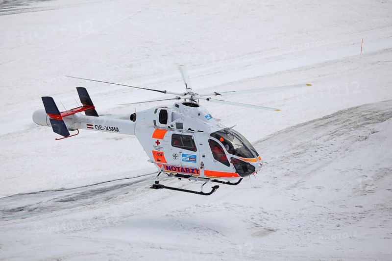 Rescue helicopter of the Austrian Red Cross in operation on the Dachstein glacier