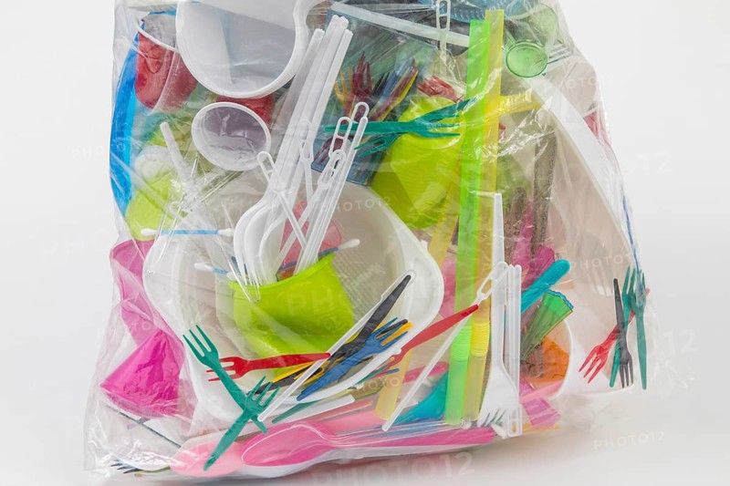 Garbage bag filled with disposable crockery