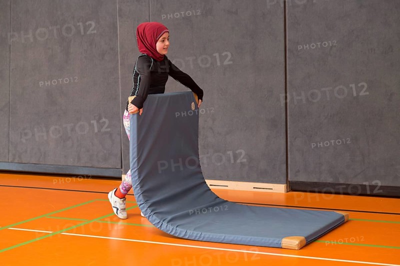 Schoolgirl wearing floor mat