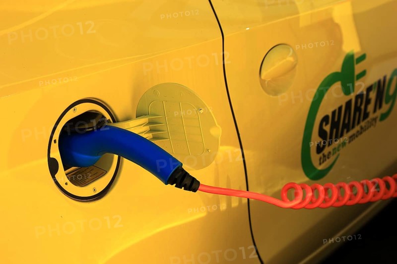 Electric car at the charging station with charging cable