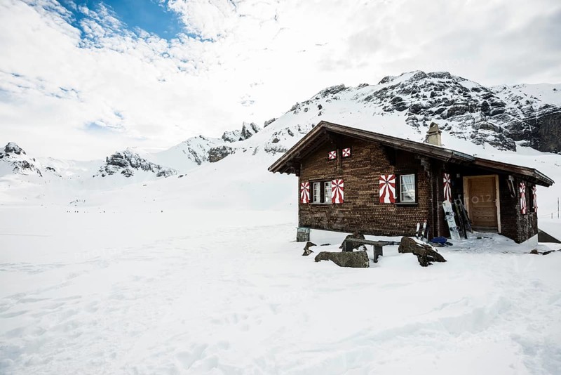 Traditional wooden chalet and snowy winter landscape