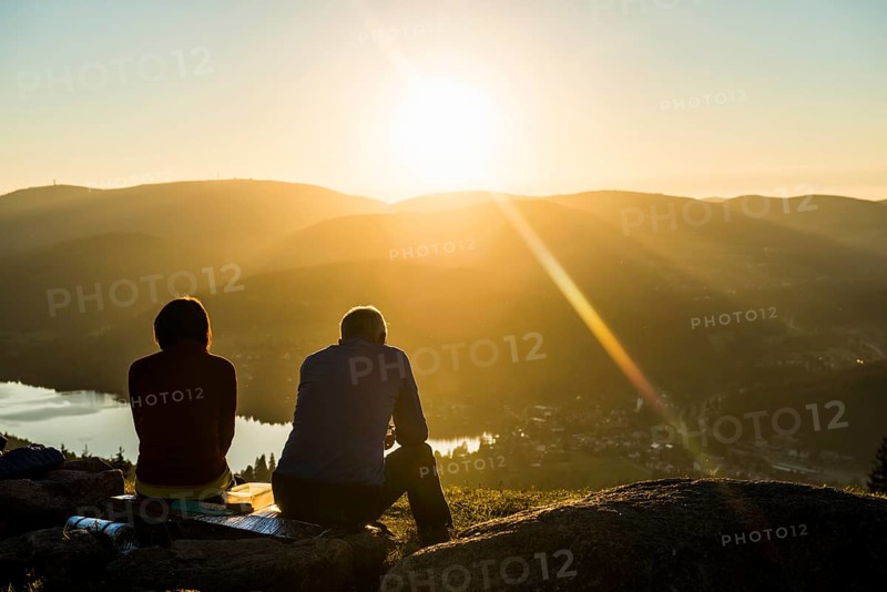 Older couple at Hochfirst with view to Titisee and Feldberg at sunset