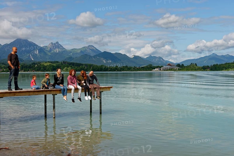 Family sitting on pier