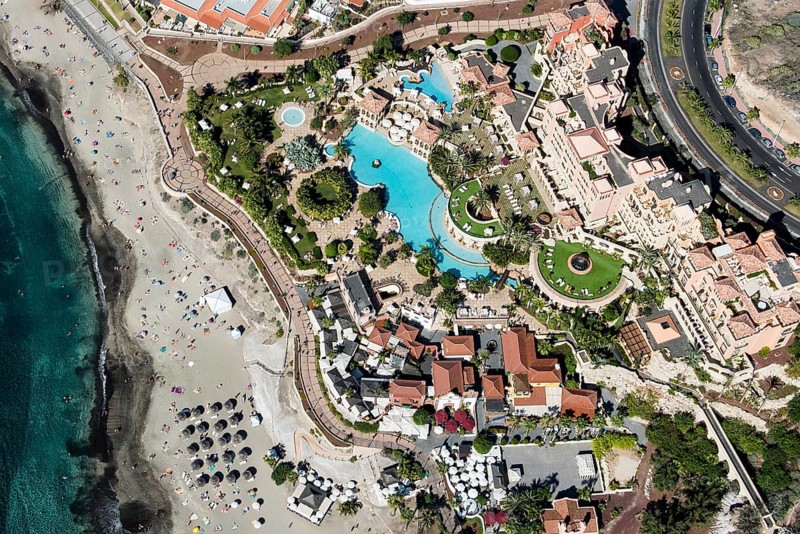 Beach with sunshades and waterfront resort with Iberostar El Mirador Gran Hotel
